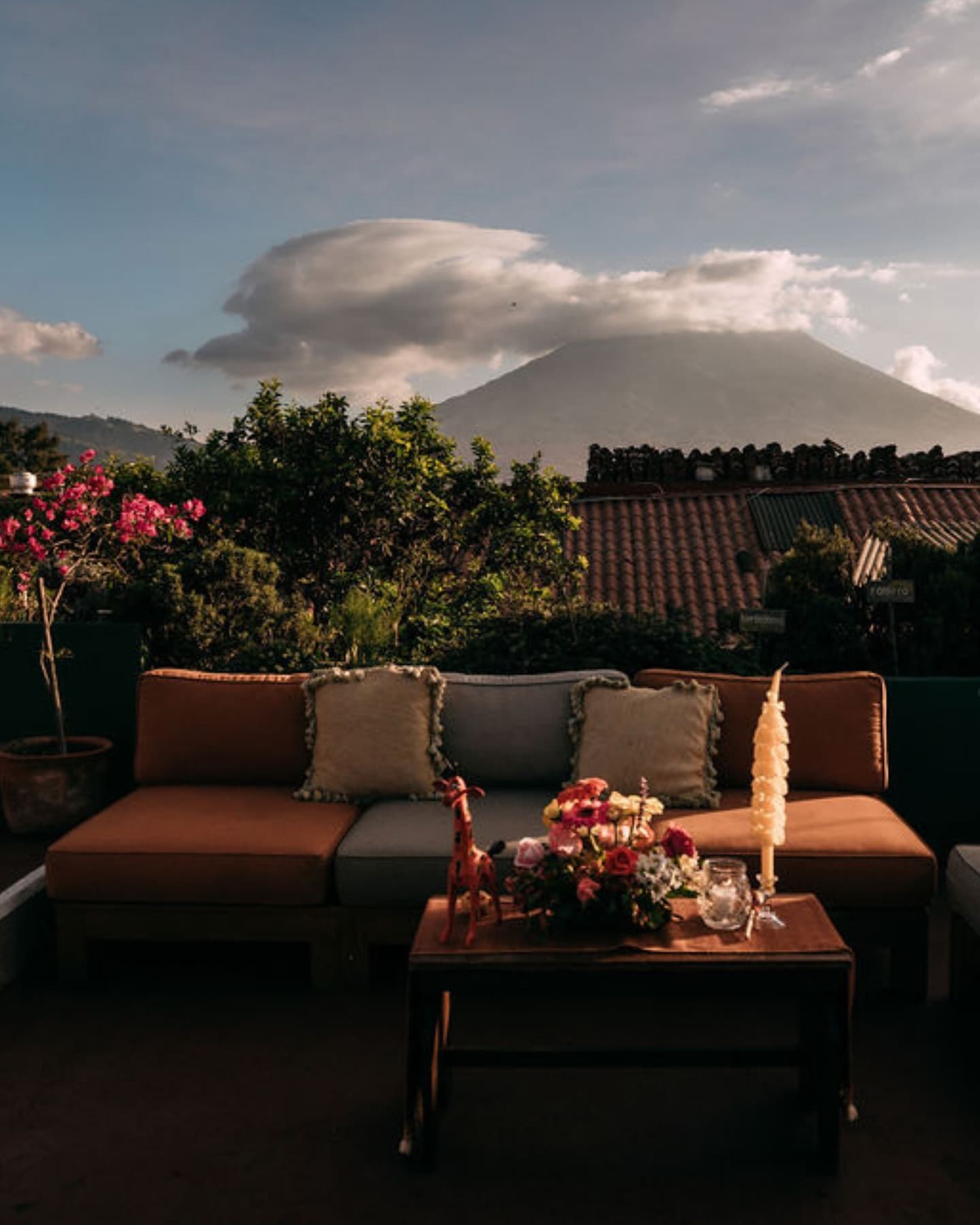 Casa Troccoli's terrace with sofas, flowers and the Agua volcano behind.